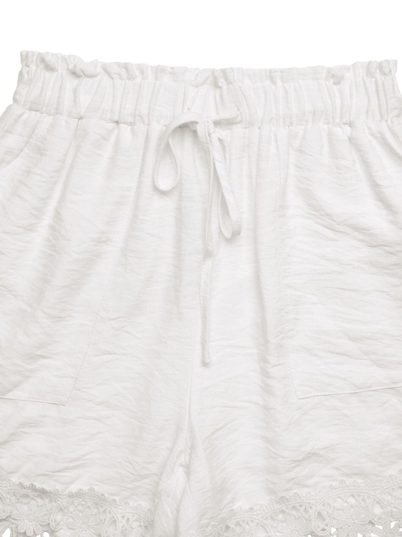 Ivory elastic-waist shorts with front drawstring and textured panel detailing
