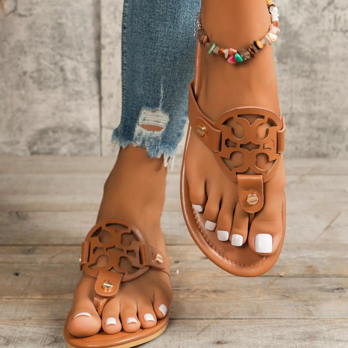 Cognac brown flat sandals with cutout logo front and metal snap buckles