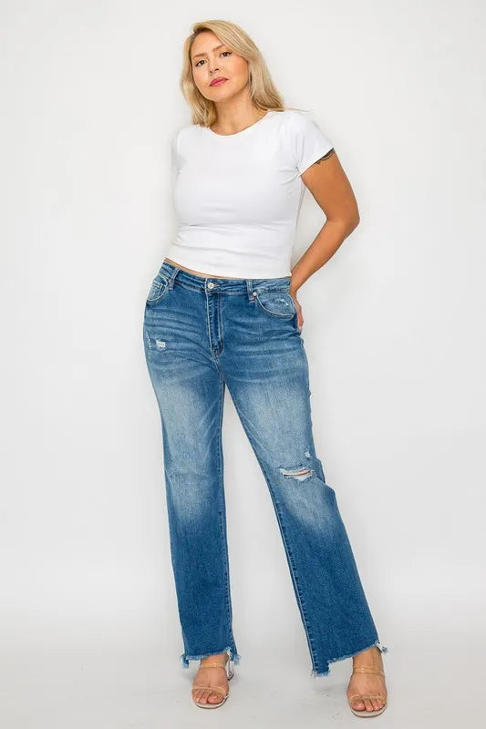 Medium-wash mid-rise straight jeans with distressed knee rips and frayed raw hem