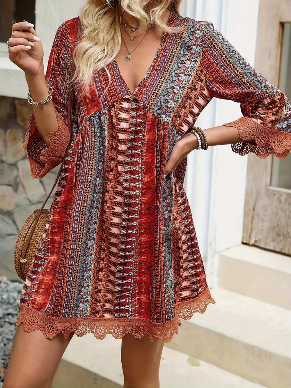 Rust patterned V-neck dress with lace cuffs, 3/4 sleeves, and crisscross front