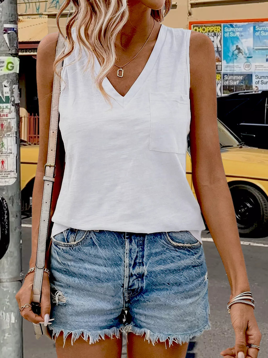 White V-neck pocket tank top with sleeveless design and straight hem