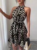Black zebra-print halter dress with tie waist and ruffle hem, flared skirt