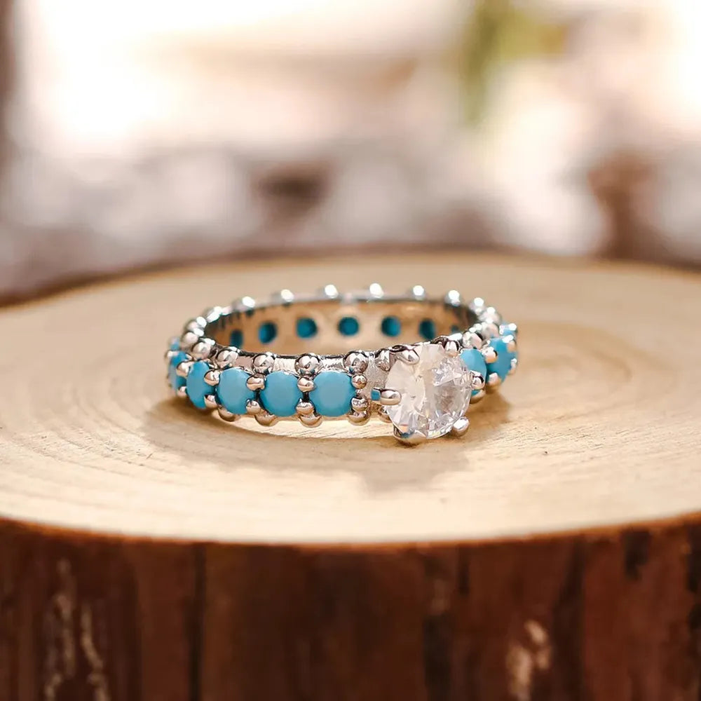 Silver-tone sterling ring with turquoise inlay and round center zircon