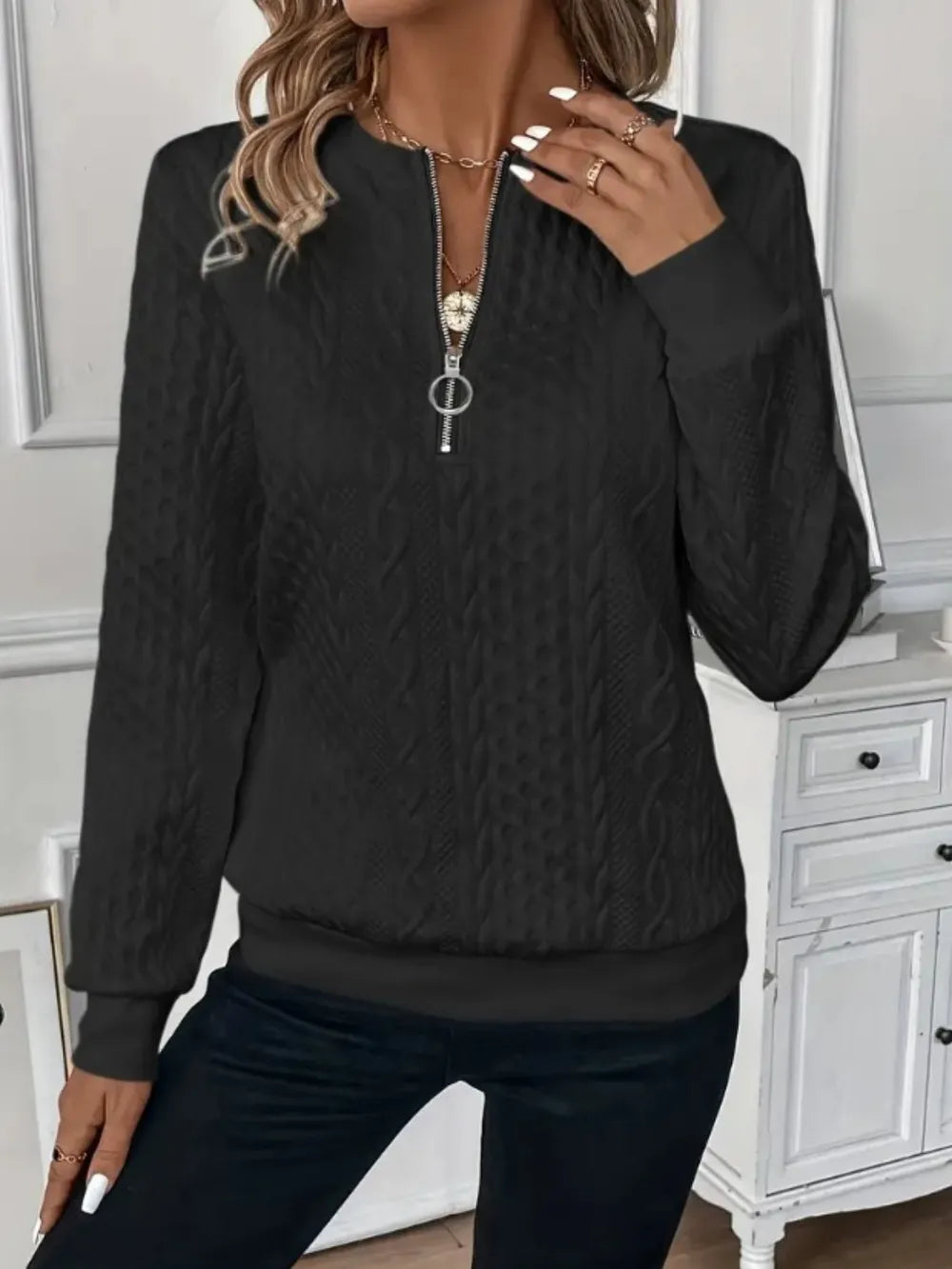 Black textured half-zip long-sleeve sweatshirt with ribbed cuffs and hem