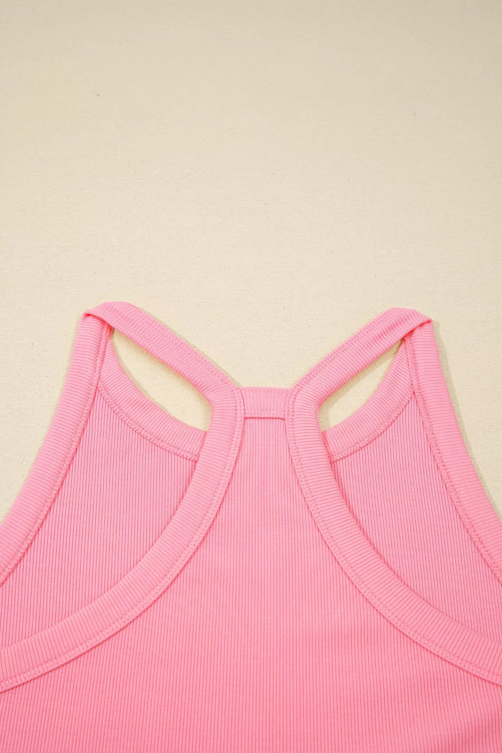 Dusty pink sleeveless cropped top with crisscross back straps and open neckline