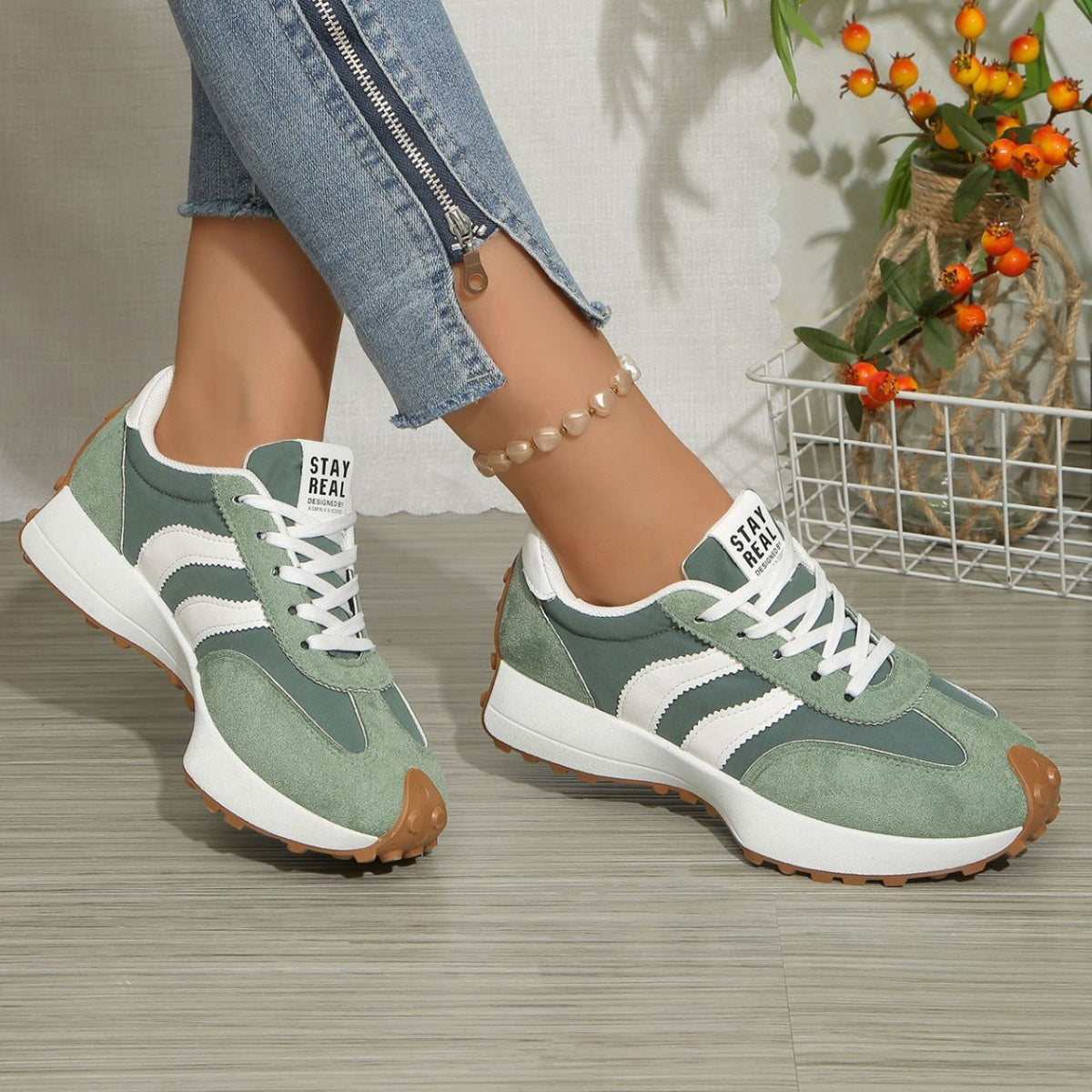 Green lace-up sneakers with white stripe detailing, round toe, grippy brown outsole