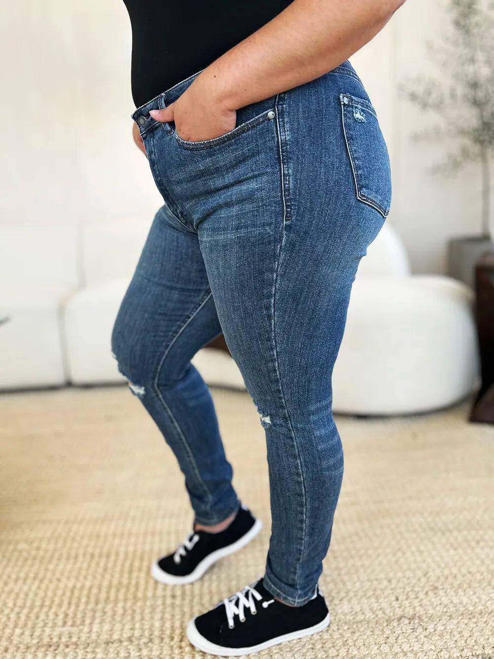 Dark blue distressed slim jeans with mid-rise fit, five-pocket styling