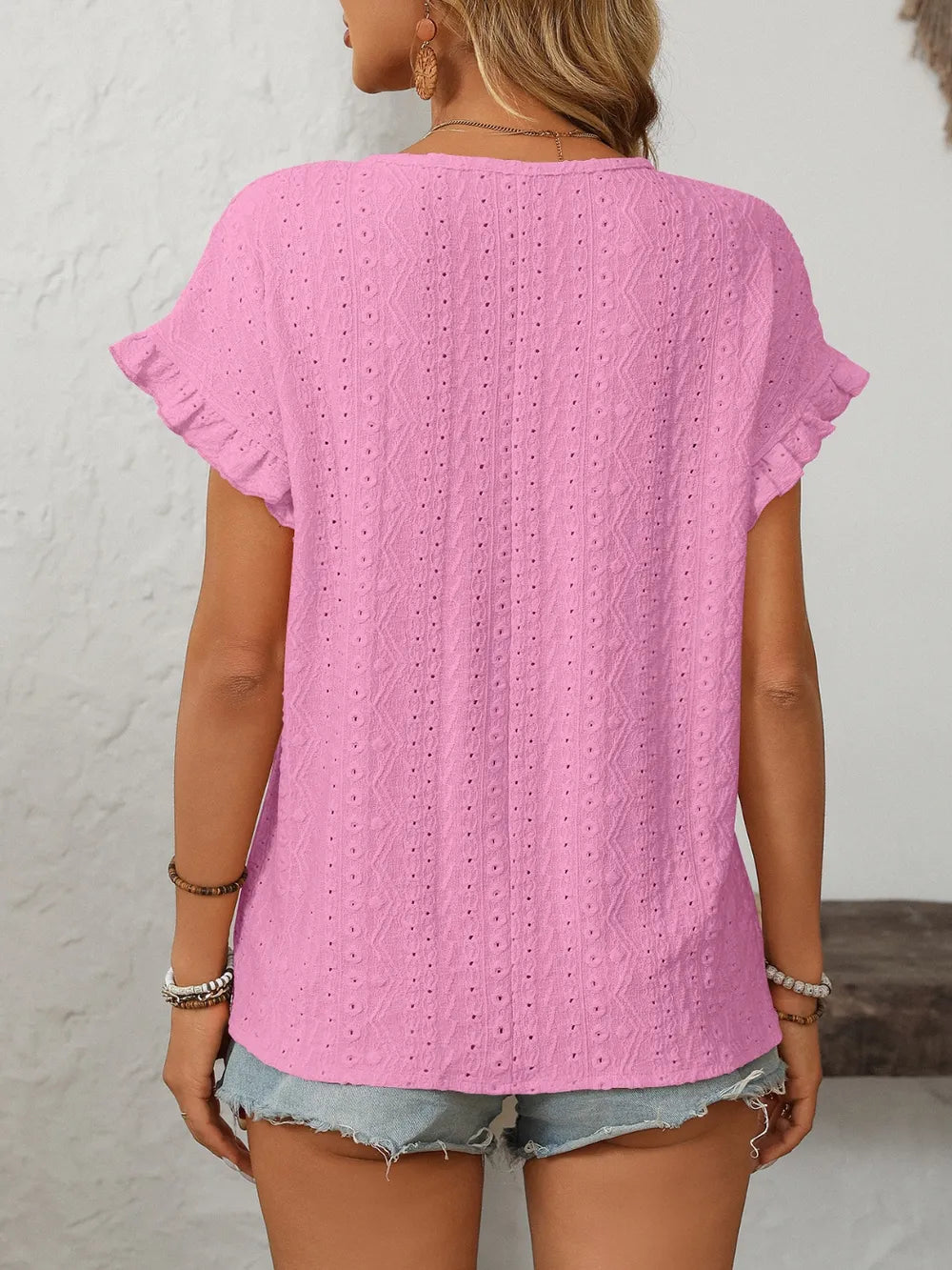 Fuchsia pink eyelet top back view with round neck and vertical textured stitch pattern