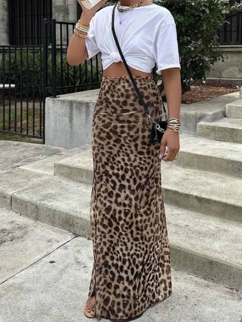 Leopard print high-waisted maxi skirt, full length draped fabric over fitted hips