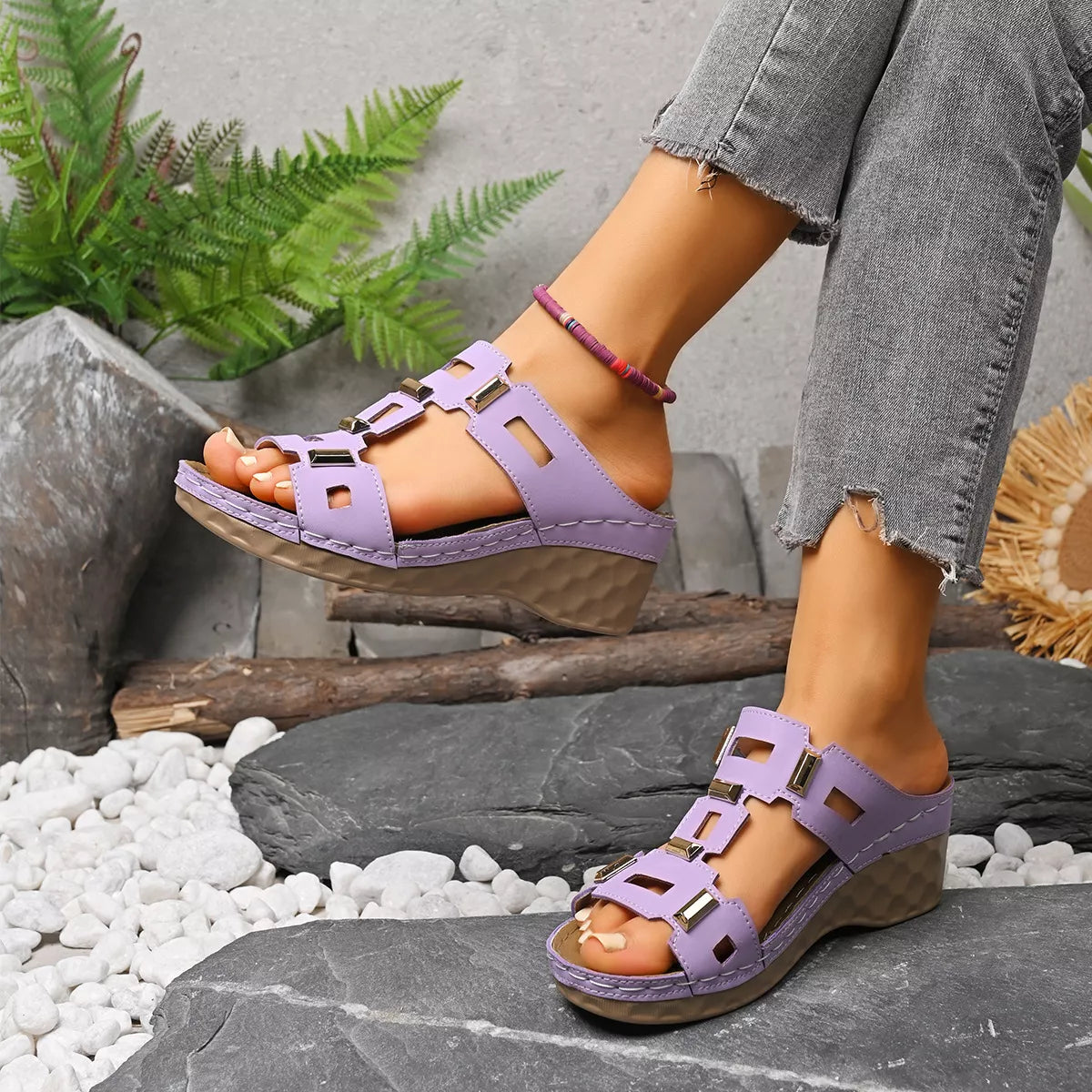 Lavender open-toe wedge sandals with cutout straps and adjustable buckle closures