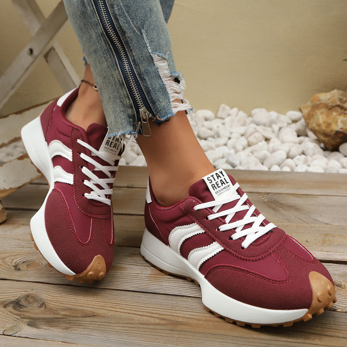Burgundy lace-up sneakers with white stripe panels, round toe, thick white sole and gum tread
