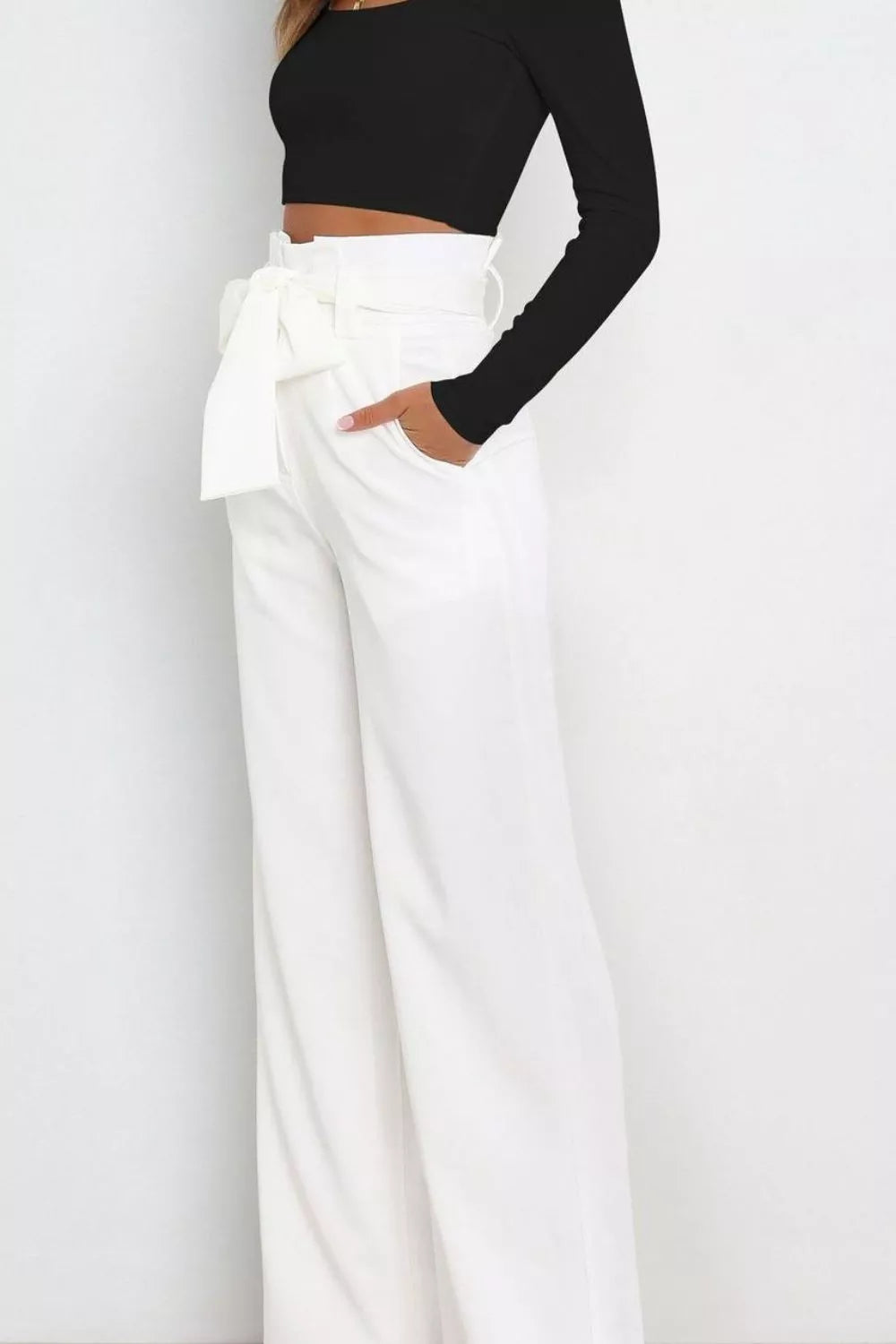 White high-waist wide-leg pants with layered front bow at waist