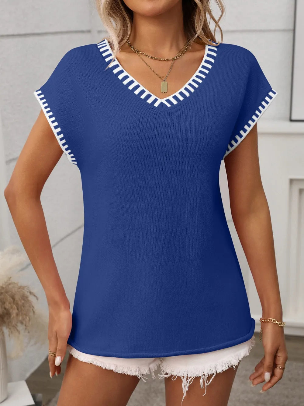 Royal blue v-neck knit top with white contrast trim and short sleeves