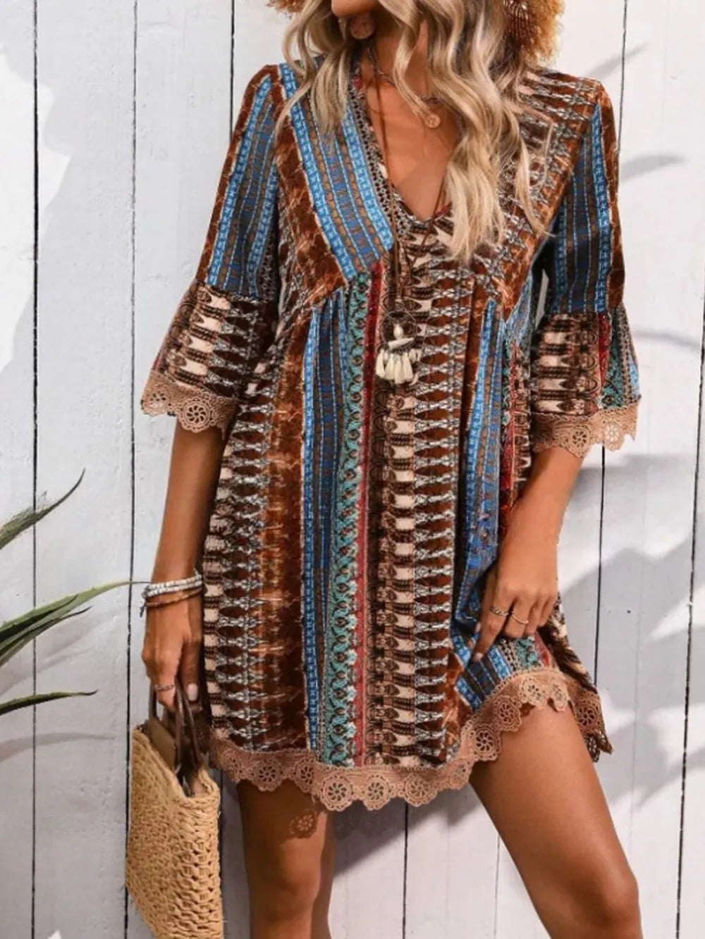 Rust and blue striped V-neck mini dress with lace hem, 3/4 sleeves, and corset front