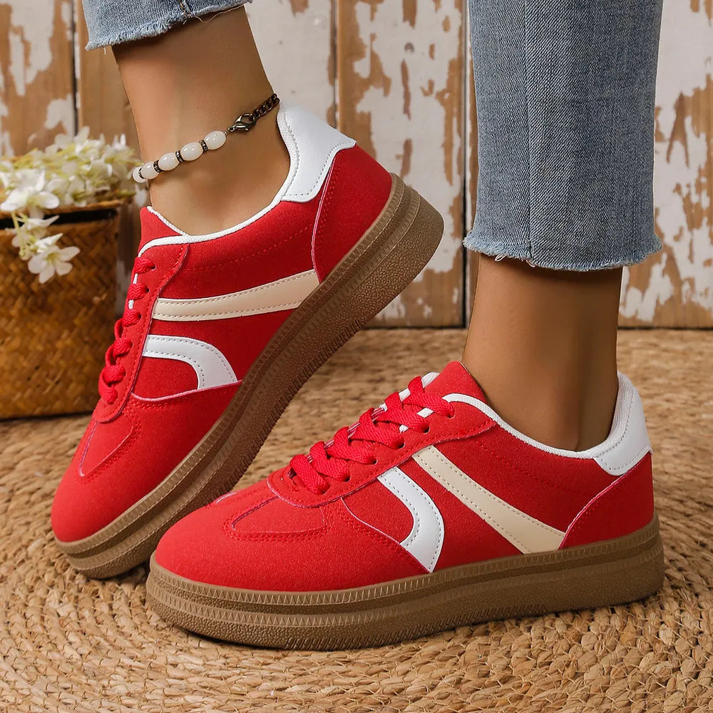 Red and white platform sneakers on feet, lace-up design with brown sole