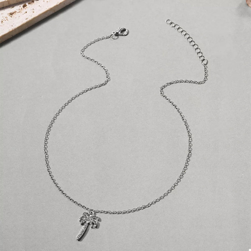 Silver palm tree pendant necklace with lobster clasp, displayed flat