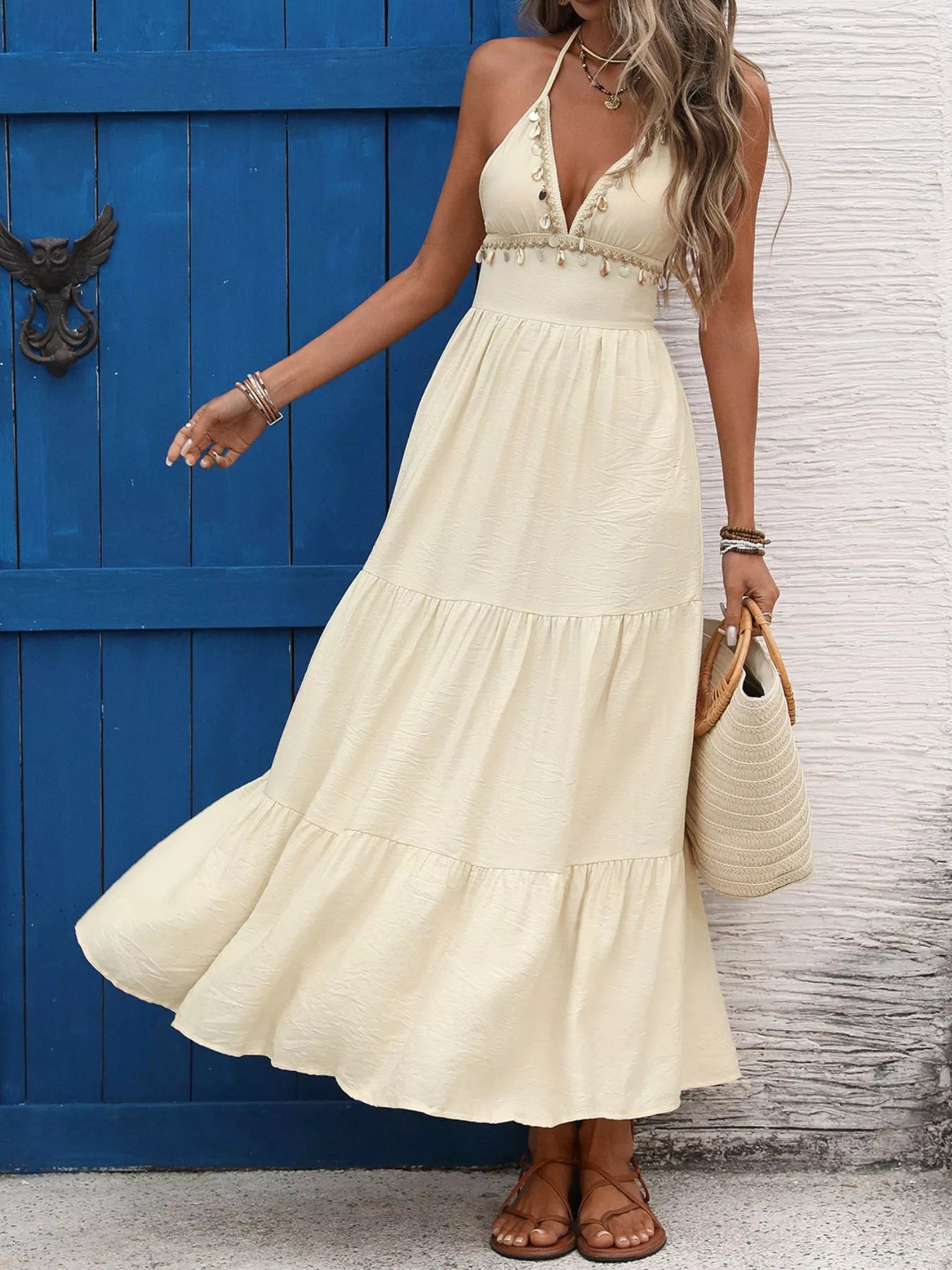 Light yellow tiered halter maxi dress with V bodice and layered hem, side view