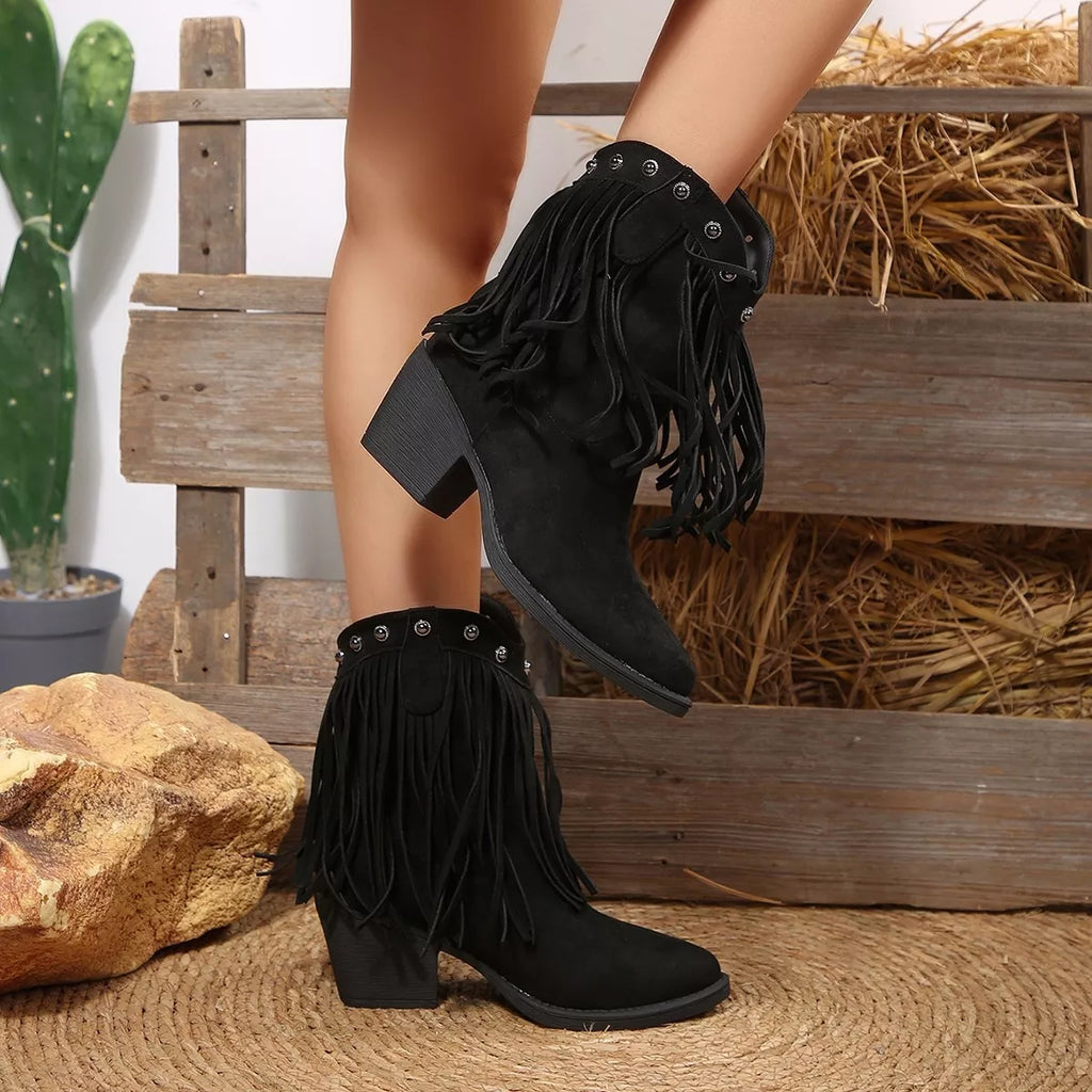 Black suede point-toe boots with long fringe and studded top, stacked block heel