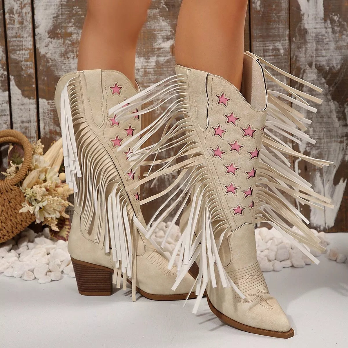 Ivory star-embroidered boots with pink accents and white fringe at sides and shafts