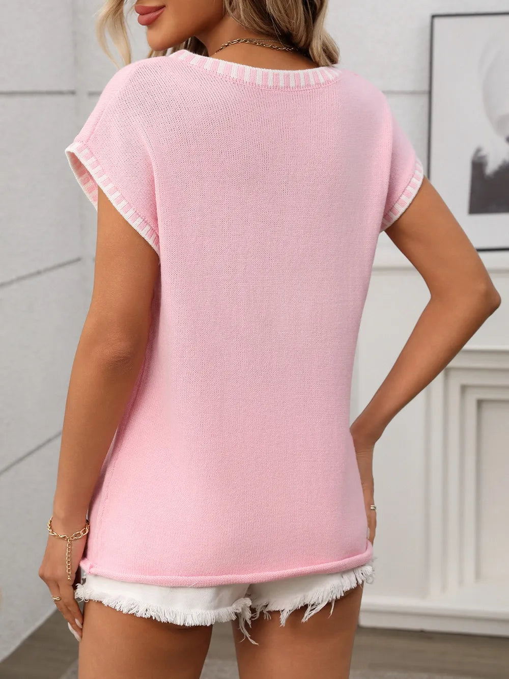 Blush pink knit short-sleeve top with striped trim at back neckline