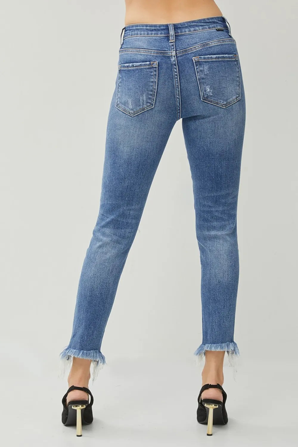 Back view slim jeans in blue with frayed cuffs and five-pocket design
