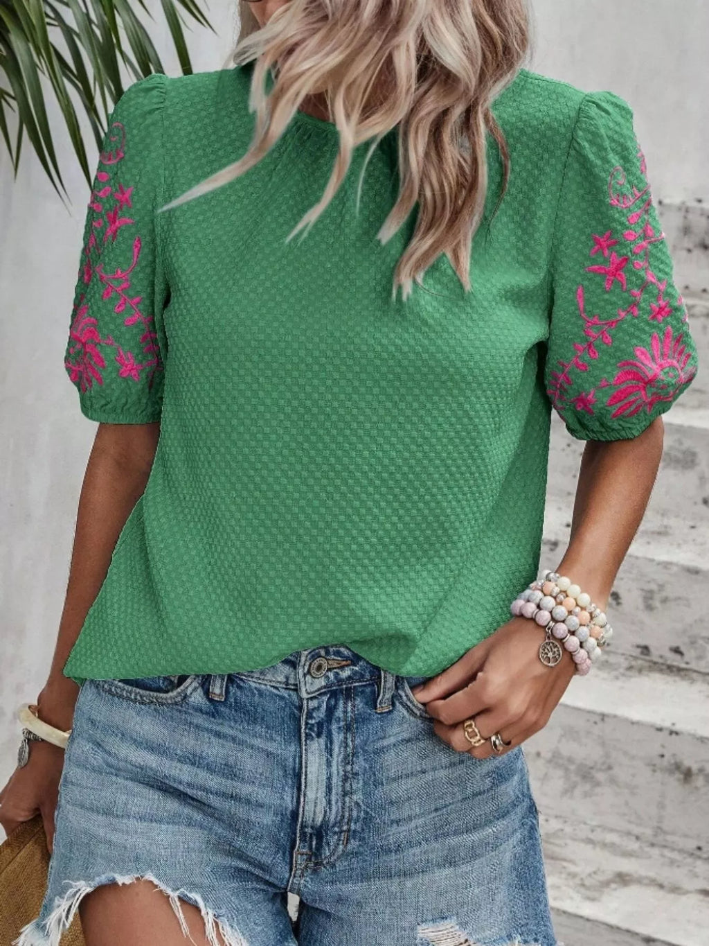 Green embroidered puff sleeve blouse with pink floral accents on the sleeves