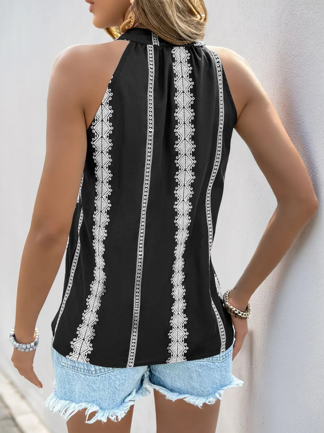 Black back of embroidered tank with white vertical trim panels