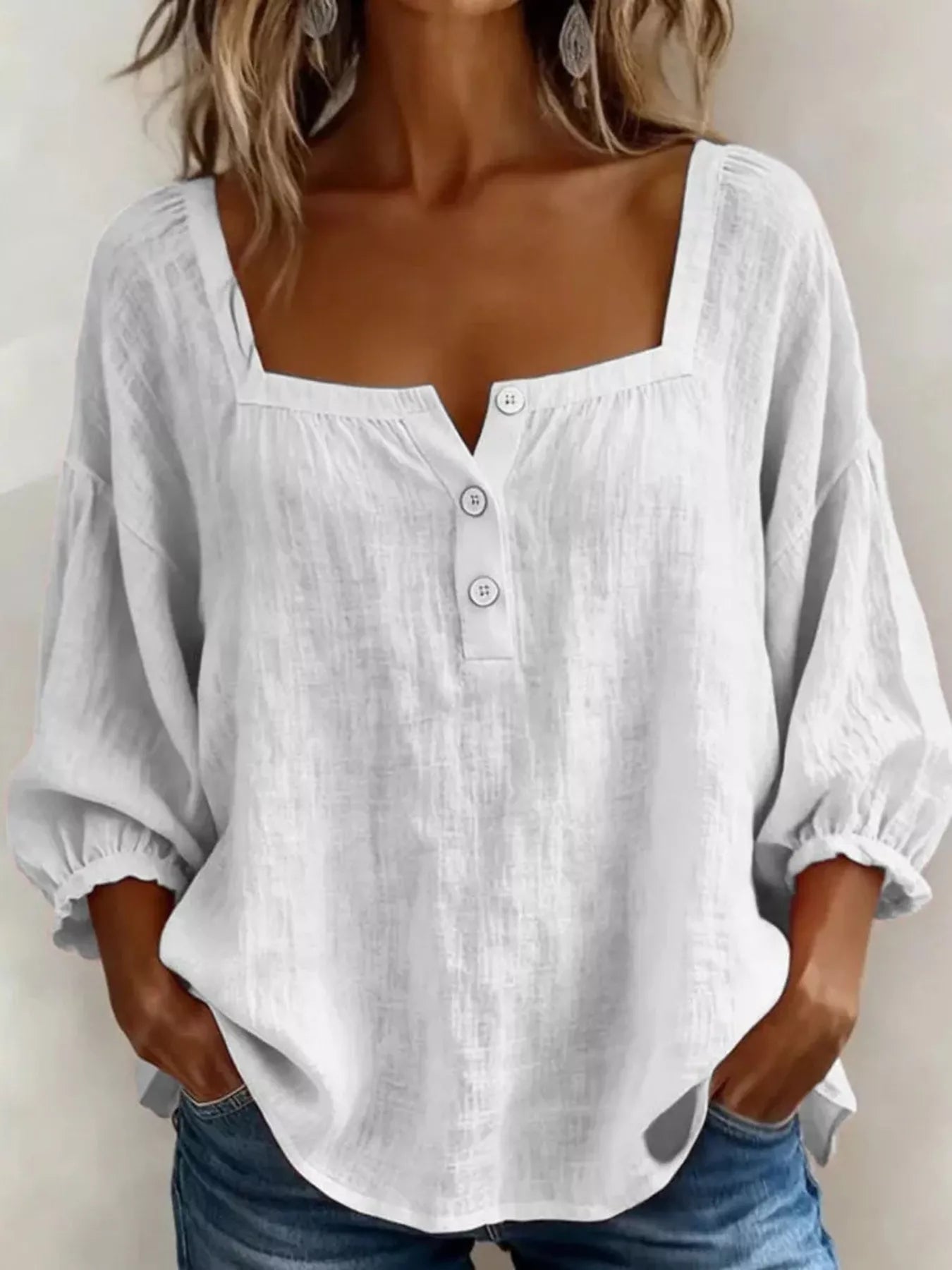 White square-neck button-detail blouse with puff sleeves and curved hem