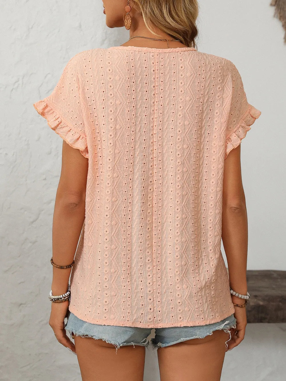 Light pink eyelet short-sleeve top, back view with flutter sleeves