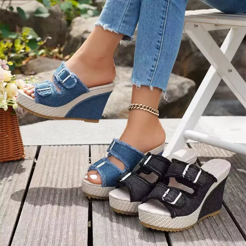 Blue denim wedge sandals with open toe, ankle strap, and two buckle closures