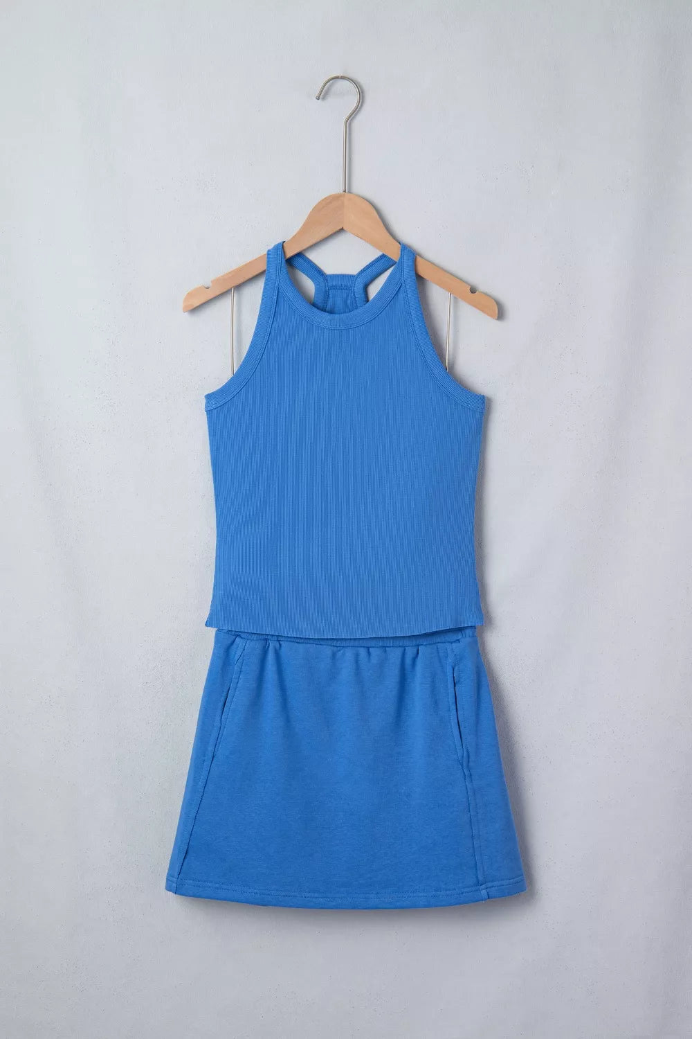 Blue sleeveless cropped top and skort set with high neck and gathered skirt hem