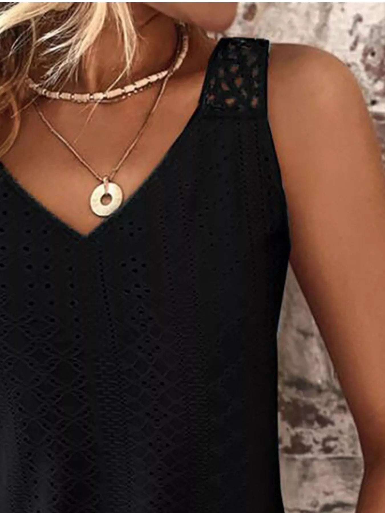 Black V-neck eyelet lace tank top with detailed embroidered front panel and sleeveless fit.
