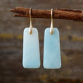 Light blue rectangular stone drop earrings with gold-tone hooks