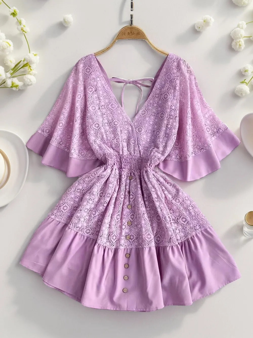 Lavender lace mini dress with tie-back, ruffle sleeves, and button front