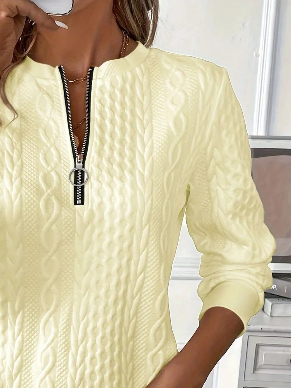 Cream textured half-zip long-sleeve sweatshirt with front zipper and stand collar