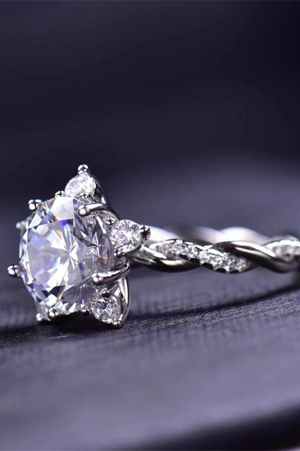 Silver 3-carat moissanite twisted ring with round center stone and diamond-like side stones