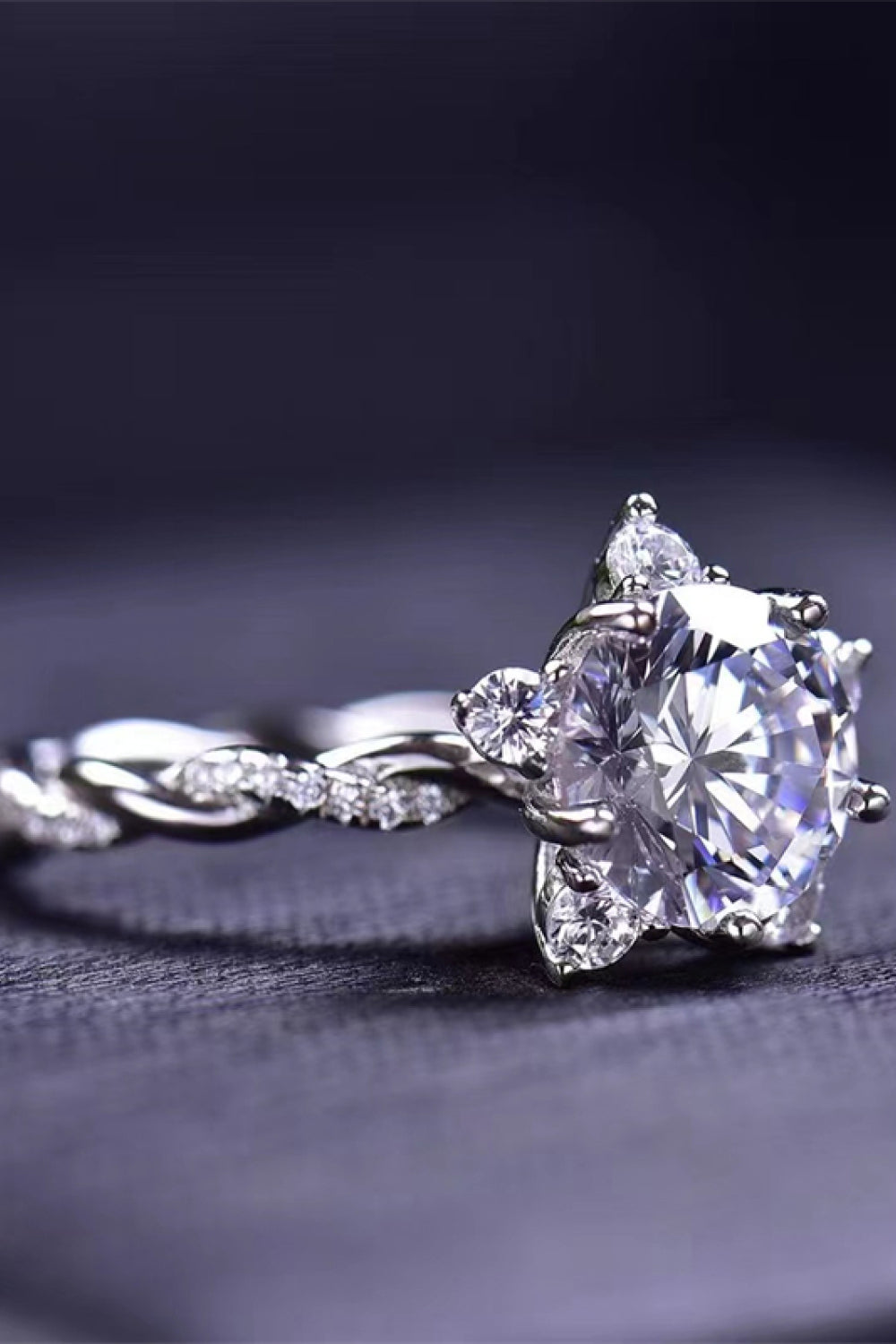 Moissanite twisted engagement ring with round center stone and sparkling halo details