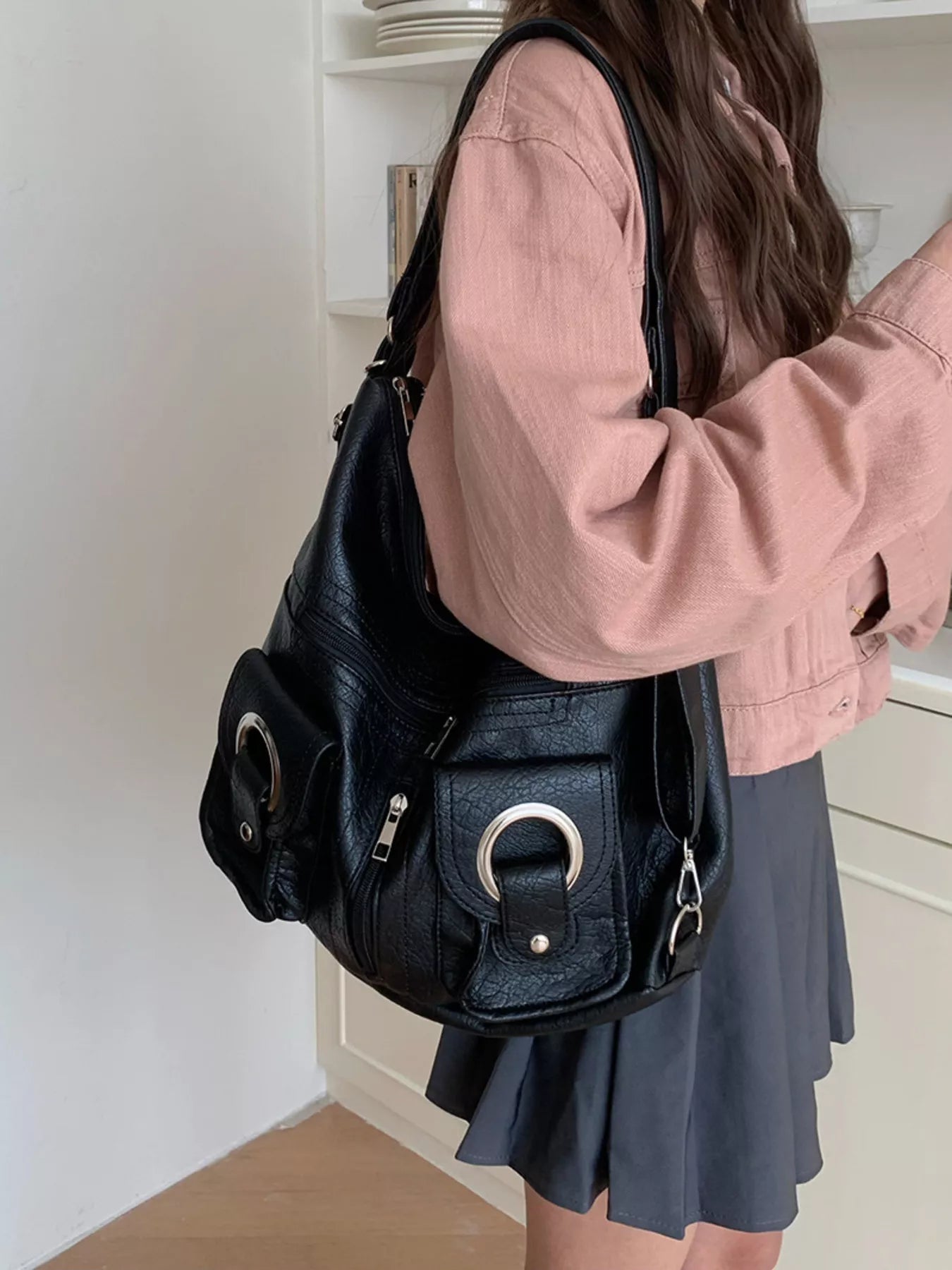 Convertible pocket handbag, black; front ring handle accents and small zip compartment
