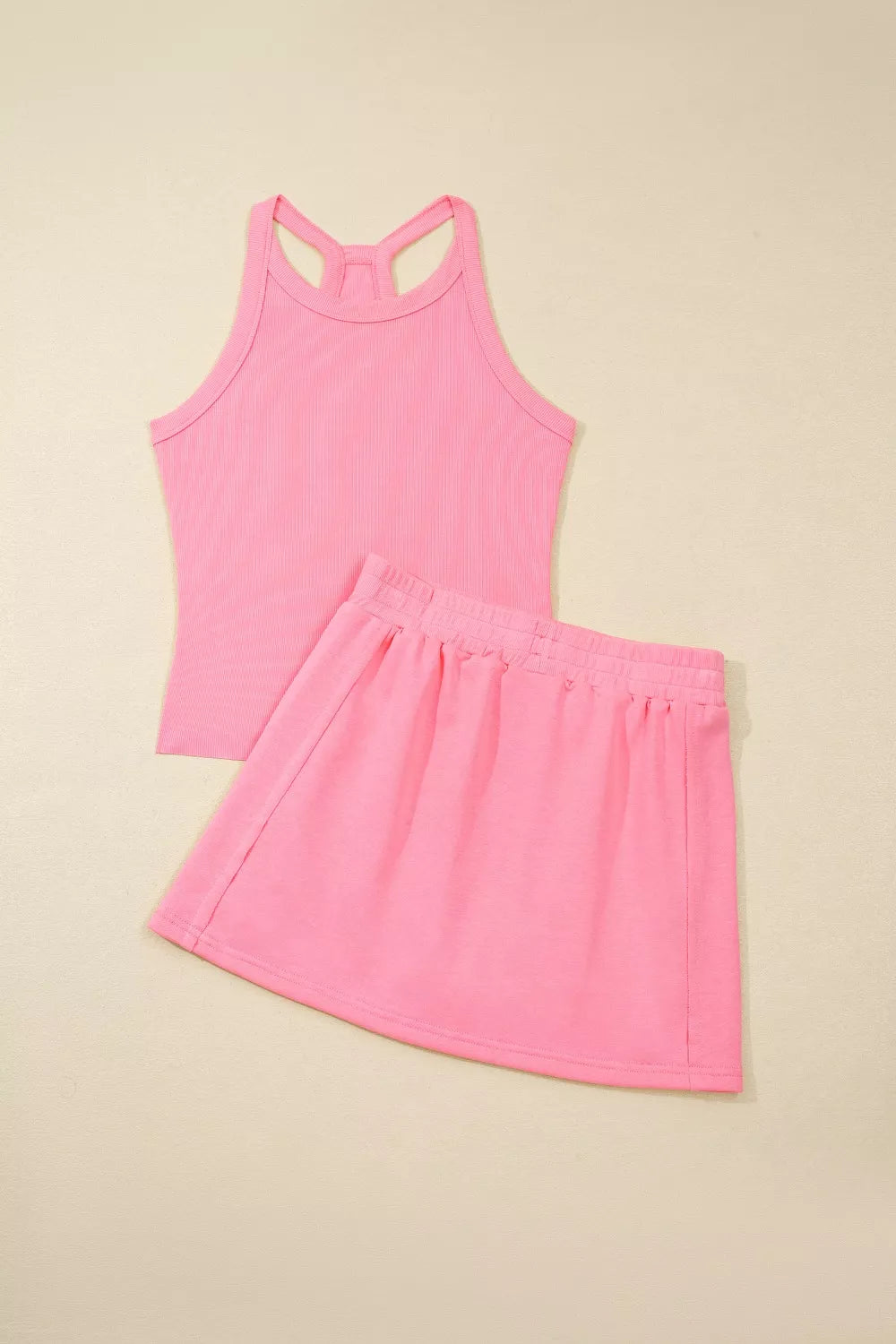Dusty pink sleeveless cropped tank top and skort, matching two-piece set