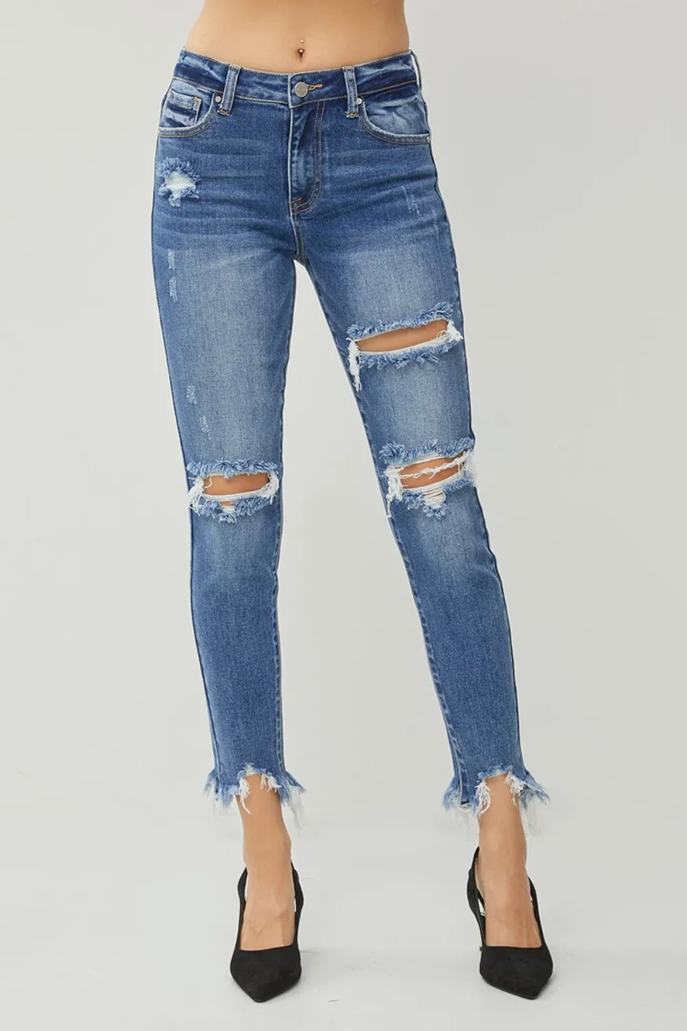 Dark blue slim jeans with ripped knees and frayed hem