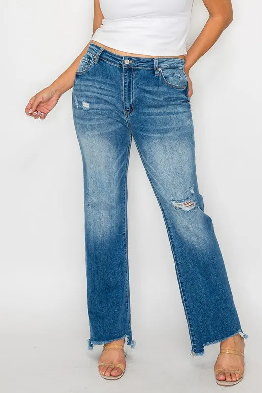 Front view of medium-wash mid-rise straight jeans with ripped patches and raw hem