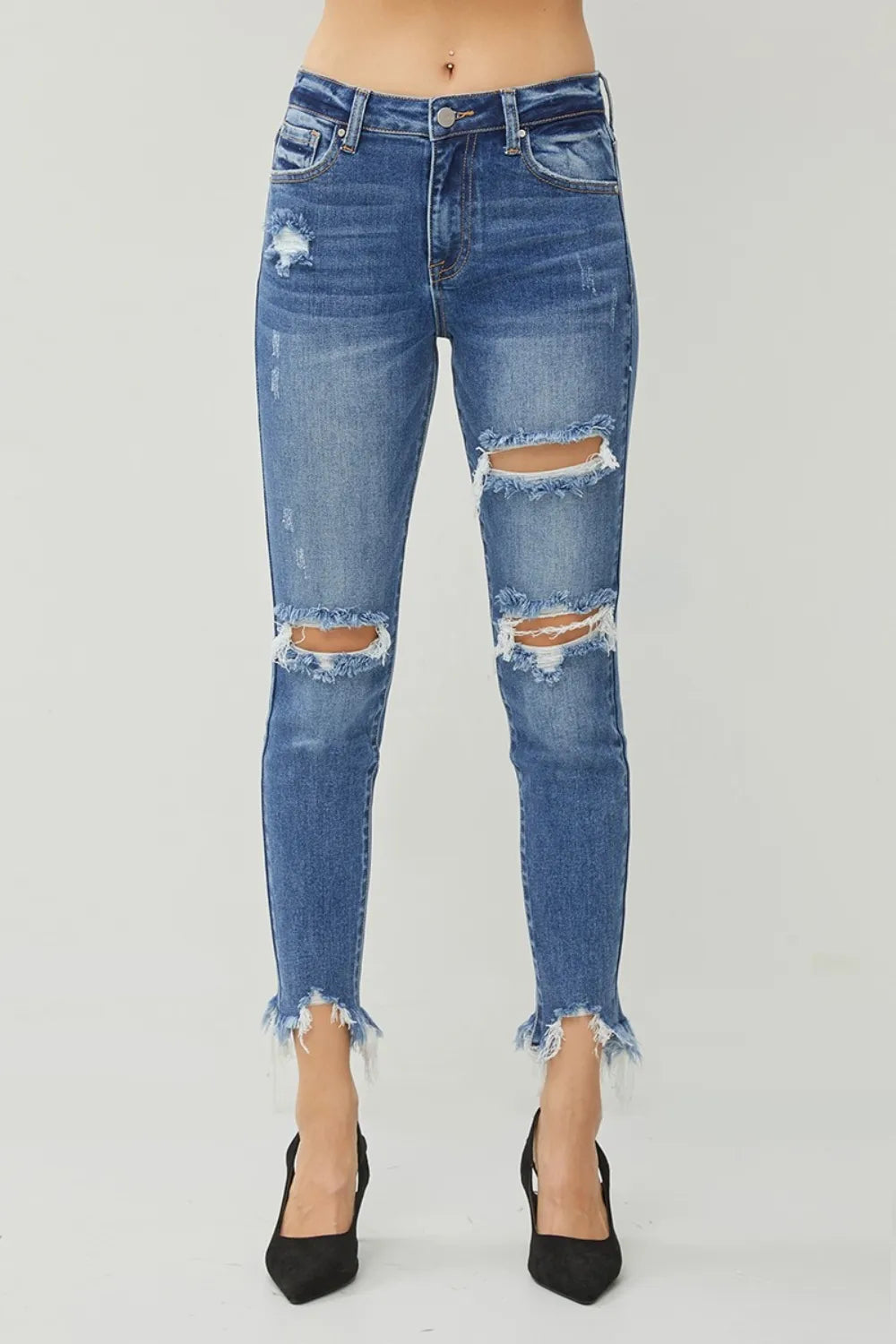 Dark wash slim jeans with whiskered distress, ripped knees, frayed hem
