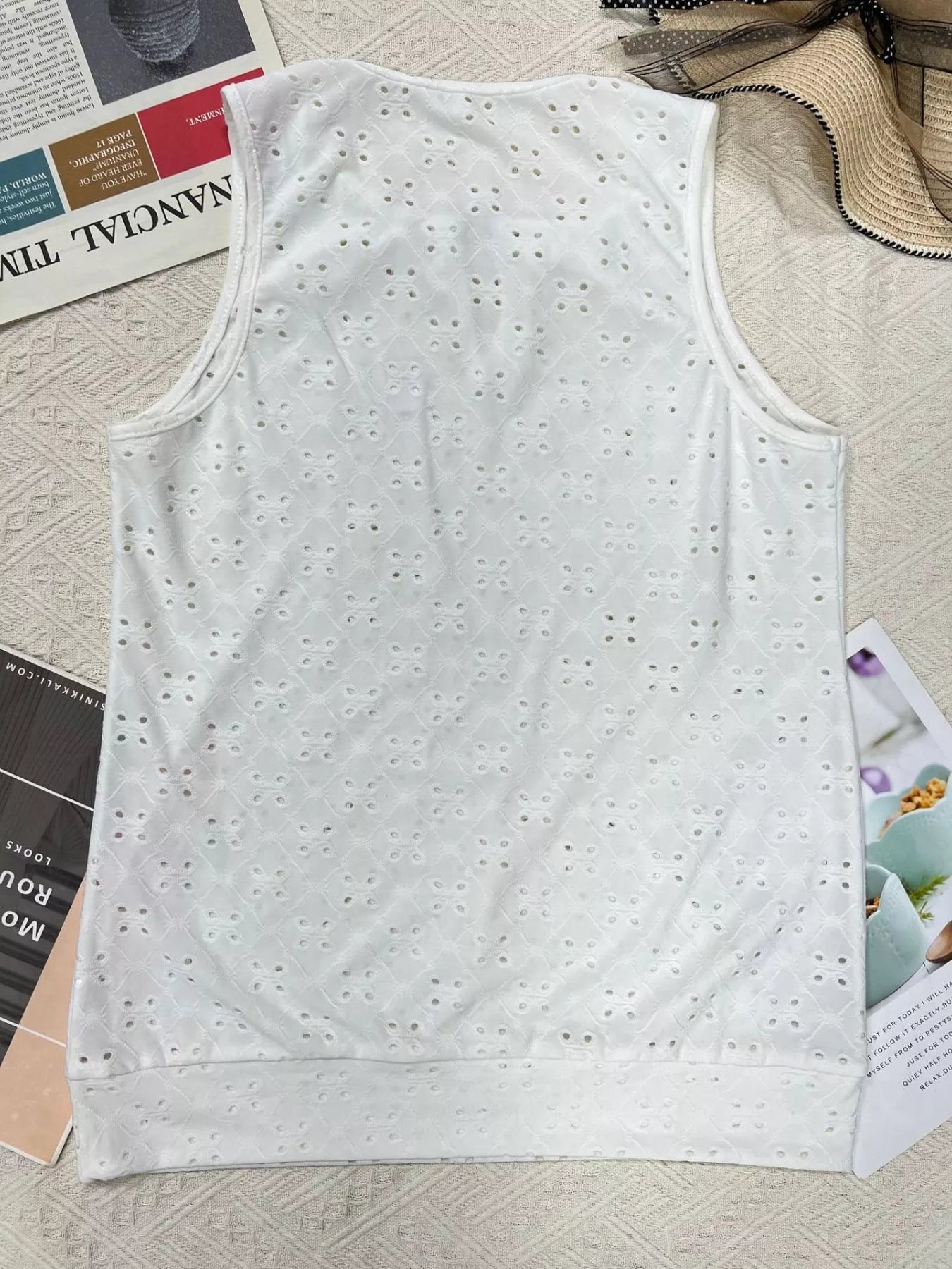 White eyelet sleeveless cami top, flat lay showing textured allover pattern