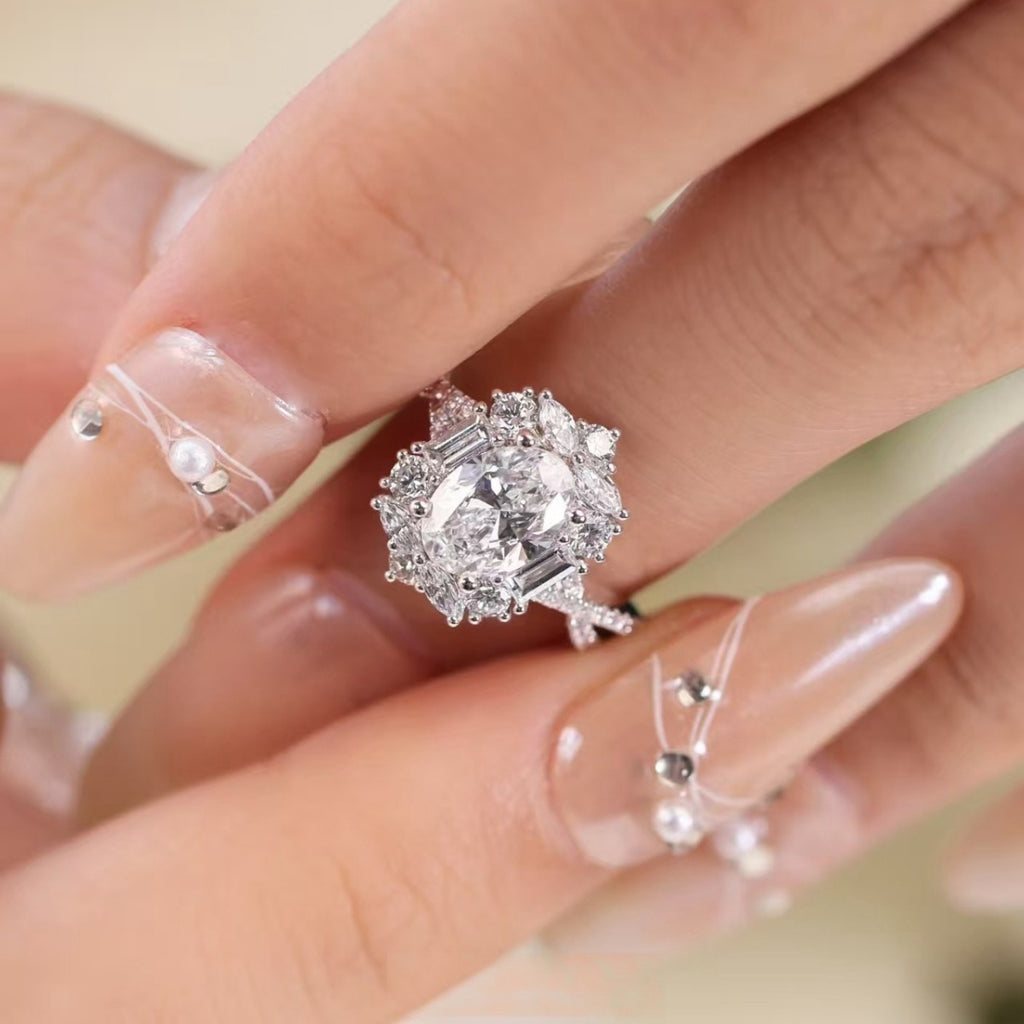 Sterling silver moissanite halo ring with oval-cut center and decorative side prongs
