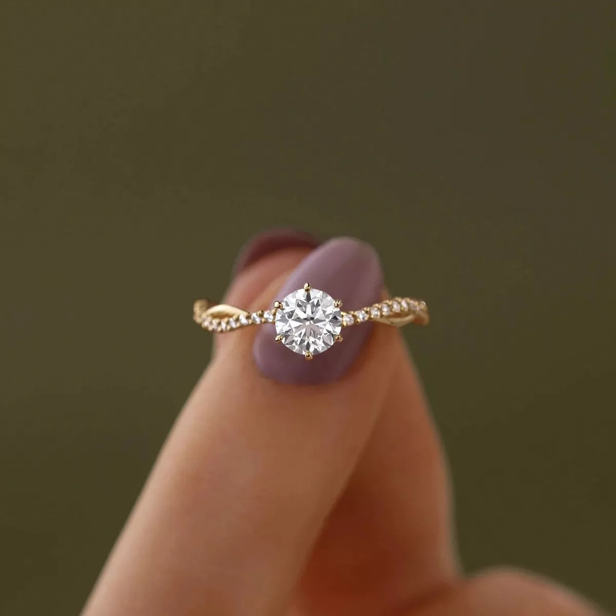 Round zircon solitaire-style ring with gold-tone pavé band and side stones