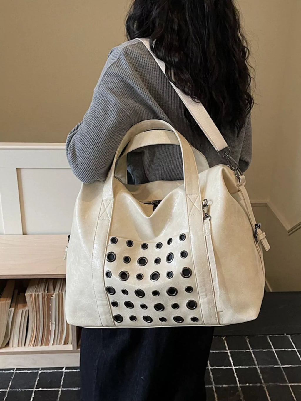 Ivory eyelet crossbody travel bag, structured top handles and perforated front pocket