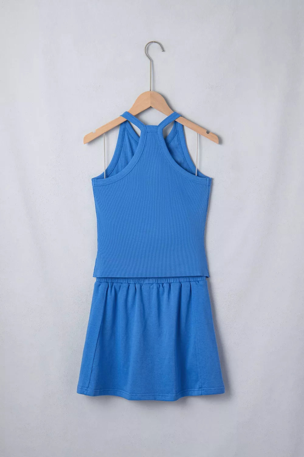 Blue sleeveless cropped top and skort set with ribbed knit texture, front view