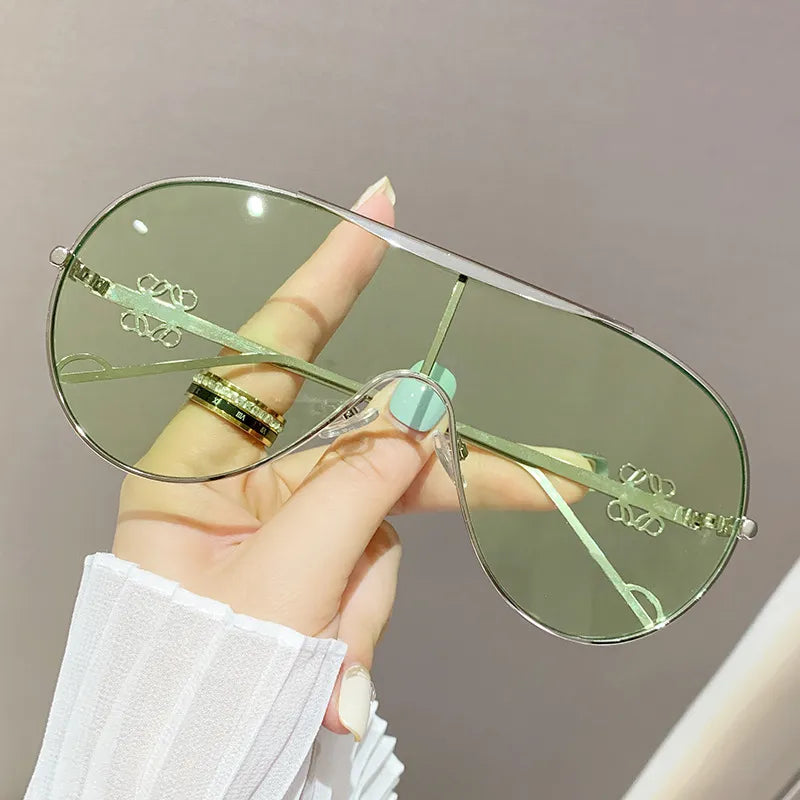 Aviator sunglasses with silver-tone frame and gradient green-tinted lenses