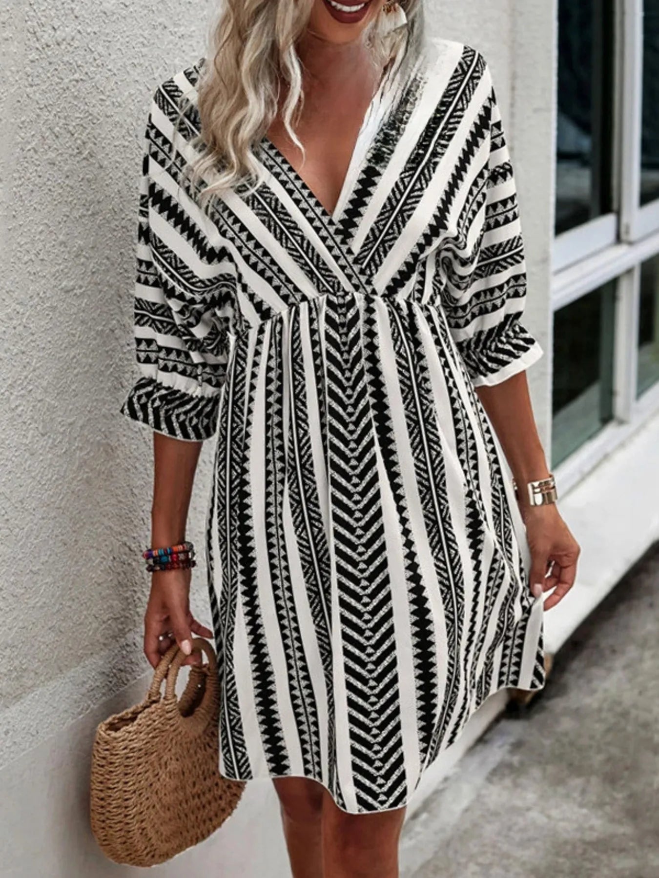 Black geometric print V-neck mini dress with gathered waist and statement ruffle sleeves
