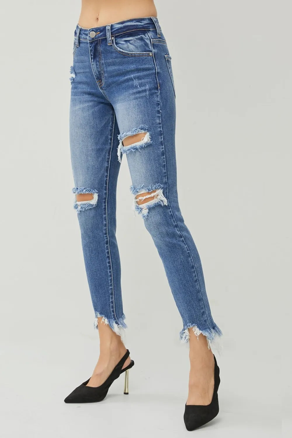 Blue slim jeans with knee rips and frayed ankle cuffs